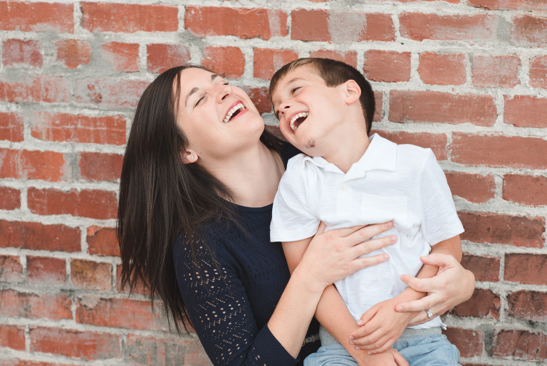 laughing mother and son, sweater dress, white polo shirt, pull-on chino shorts for boys, downtown Petaluma