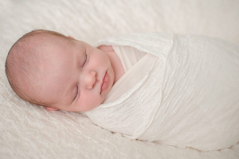 newborn baby girl, textured white background, white swaddle, Photography by Emily Payne, sleeping newborn baby